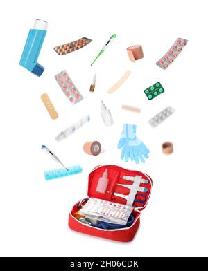 Medical items falling into red case on white background. Packing first aid kit