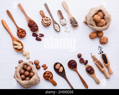 Hemp Sack bags and spoon of various legumes and different kinds of nuts walnuts kernels ,hazelnuts, almond kernels,brown pinto ,red kidney beans and p Stock Photo