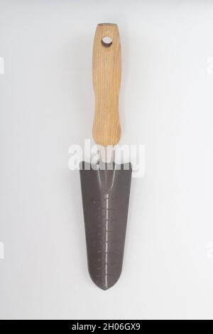 Small shovel with scale and wooden handle, gardening tool isolated on white background Stock Photo