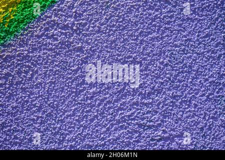 Vivid purple monochrome textured background with sprayed painted wall like graffiti art, made with with vivid green colors Stock Photo