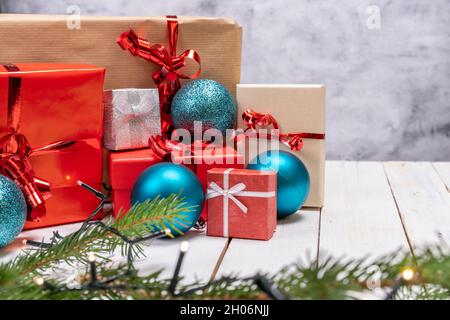 Christmas holiday composition with gift boxes on white wooden background. Christmas presents with red, brown and gray paper with red ribbon Stock Photo