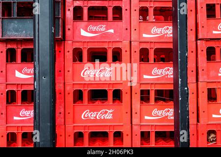 Bucharest, Romania, 13 February 2021 - Old red plastic boxed of Coca Cola drink abandoned in a food market Stock Photo