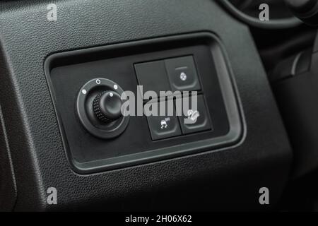 Side mirrors control panel on side door. Car driver adjust side mirror controller. Side mirror control button for adjusting the side mirrors. Stock Photo