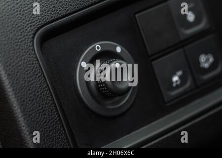 Side mirrors control panel on side door. Car driver adjust side mirror controller. Side mirror control button for adjusting the side mirrors. Stock Photo