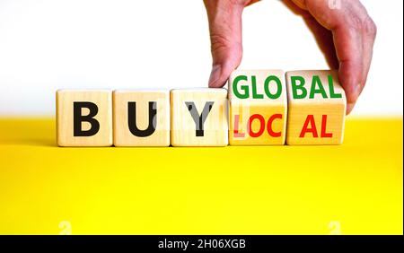 Downtown het beleid spoel Buy local or global symbol. Businessman turns wooden cubes, changes words  'buy local' to 'buy global'. Beautiful yellow table, white background.  Busin Stock Photo - Alamy