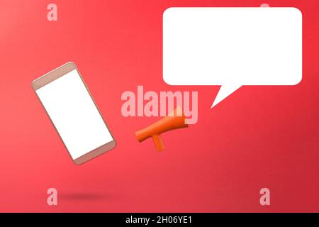 Blank white speech bubble with grey 3d smartphone and megaphone  icon against red background. 3D illustration design template. Top mobile phone messag Stock Photo