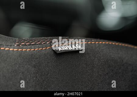 Close up view of airbag label on the side of a car seat. Airbag safety system symbol on the car seat. Modern car interior details. Stock Photo