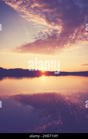 Scenic sunset over the water, color toning applied. Stock Photo