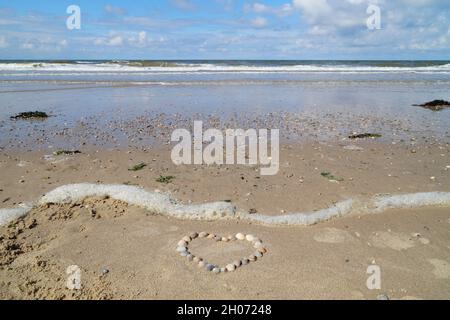 a heart made of seashells on the beautiful beach of Baltrum Island in the North Sea (Germany) Stock Photo