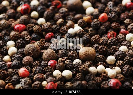 A mixture of peppercorns as a textural background in full screen. Spices Stock Photo