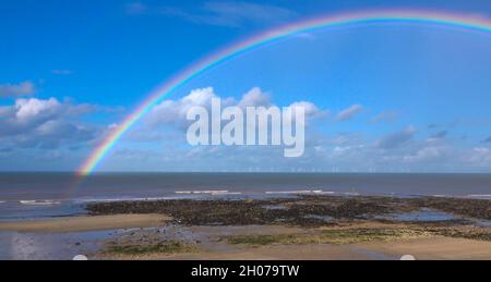 rainbow over Gwynt y Môr (Sea wind) 576-megawatt offshore electricity generating wind farm; 160 x 150m high wind turbines in action, Colwyn Bay Wales Stock Photo