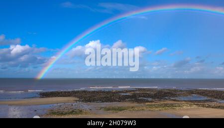 rainbow over Gwynt y Môr (Sea wind) 576-megawatt offshore electricity generating wind farm; 160 x 150m high wind turbines in action, Colwyn Bay Wales Stock Photo