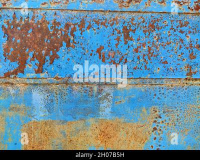 Rusty metal panel with cracked blue paint, corroded grunge metal background texture Stock Photo