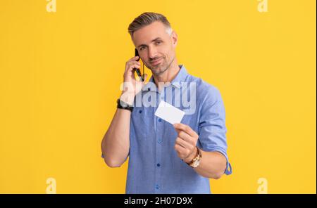 guy speak on smartphone. customer use online money on mobile phone. Stock Photo