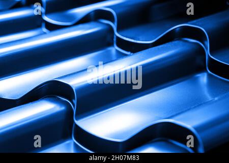 Metallic roof tile in blue color. Abstract industrial surface background close up. Stock Photo