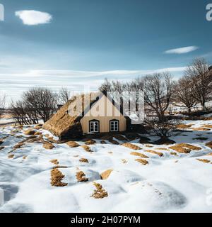 Hofskirkja Church, Hof, Iceland in winter with snow and blue sky. This fairytale-like building is the last turf church ever built in Iceland. this Stock Photo