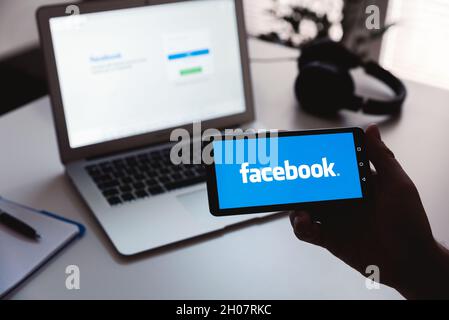 Wroclaw, Poland - JUN 17, 2021: Man using Facebook appication on Huawei P30 smart phone. Facebook is most popular social media service. Stock Photo