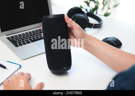 Man using smart speaker. Modern smart home device, intelligent assistant appliance Stock Photo