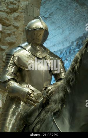 Medieval knight in armour on horseback displayed at the Tower of London, London, England, UK