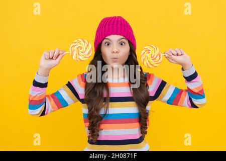 making face. lollipop lady. hipster kid with colorful lollypop sugar candy on stick. caramel candy Stock Photo