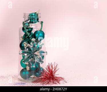 Vintage Glass Bottle with Green Christmas Ornaments Within - Room for Copy Stock Photo