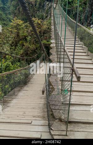 Suspension bridges leading to the viewpoint on Pailon del Diablo (Devil's Cauldron) waterfall near Banos town, Ecuador Stock Photo