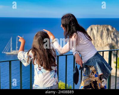 Mother and daughter looking at the sea from a viewpoint on a sunny day Stock Photo