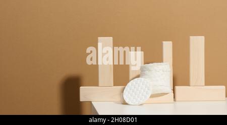 White cotton sponges on a white table. Design for the beauty, medicine and cosmetics industry Stock Photo