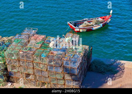 Fishing boat and a string of fishing nets and cages in the Bay of Cascais, Lisbon District, Portugal Stock Photo