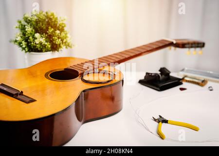 Restring classical guitar concept. Closeup at the new strings. Stock Photo