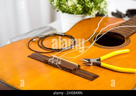 Restring classical guitar concept. Closeup at the new strings. Stock Photo