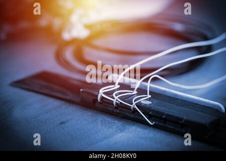 Restring classical guitar concept. Closeup at the new strings. Stock Photo