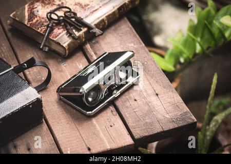 Closeup vintage folding opera glasses. Old compact binoculars. Stock Photo