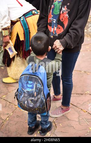 A Native American woman and her young son hold hands as they wait for the start of the Indigenous Peoples' Day celebration in Santa Fe, New Mexico. Stock Photo