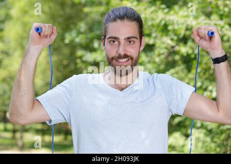 sporty man with jumping rope Stock Photo
