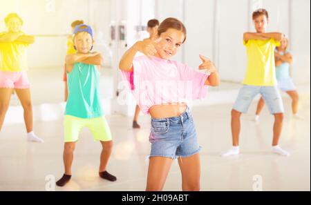 Tween girl krump dancer in choreographic studio with children Stock Photo