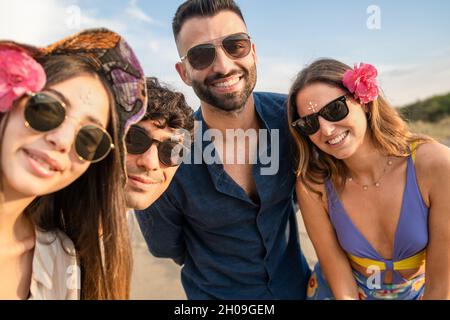 Portrait of four young people having fun in the summer. Summertime vivid warm colors Stock Photo