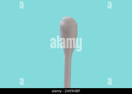 A white cotton bud with plastic material, isolated on a blue background, the concept of health, beauty, and hygiene Stock Photo