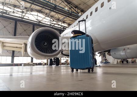 Suitcase of air stewardesses in empty airport hangar Stock Photo