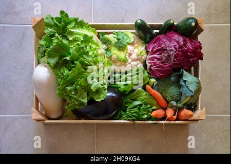 Directly above shot of healthy vegetables in wooden container Stock Photo