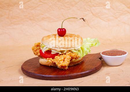 Juicy fish burger, hamburger or cheeseburger with one fish patties, with sauce. Concept of American fast food. Copy space Stock Photo