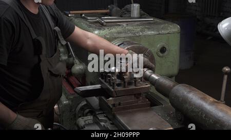 Shooting of working process with metal details on lathe Stock Photo