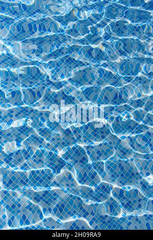 Swimming pool mosaic bottom caustics ripple like sea water and flow with waves background with sun light reflection, sport and relax concept Stock Photo
