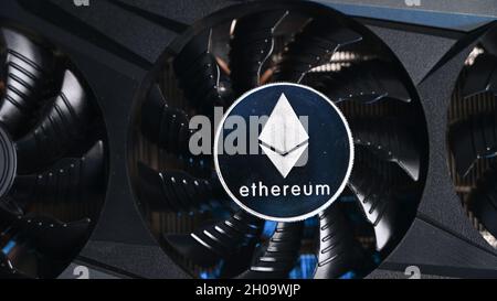 Close up of Ethereum coin on a black grafic video card. Cryptocurrency business device. Ethereum miners Stock Photo