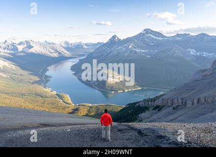 Man enjoying the view on alpine valley and lake after reaching mountain summit in Canadian Rockies,Rimwall Summit,Canada Stock Photo