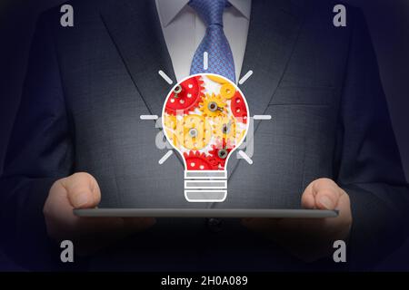 Business concept background with gears inside light bulb icon Stock Photo