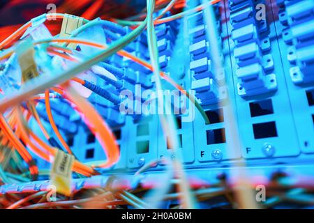 Illuminated patch panel inside server cabinet with connected cables Stock Photo