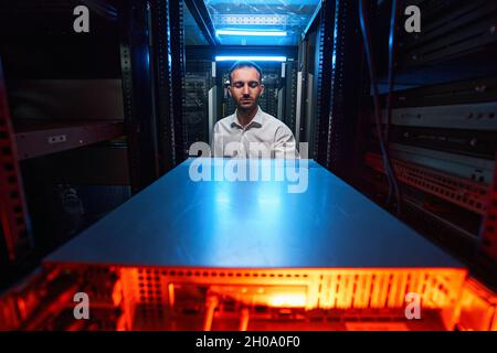 Data center worker doing maintenance of computer equipment Stock Photo