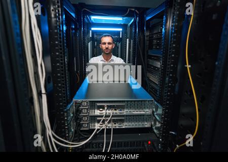 Data center server administrator checking equipment functionalities Stock Photo