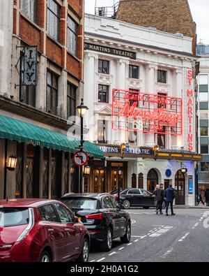 London's West End theatre district with 'The Mousetrap' in production at St. Martin's Theatre across from The Ivy club. Stock Photo
